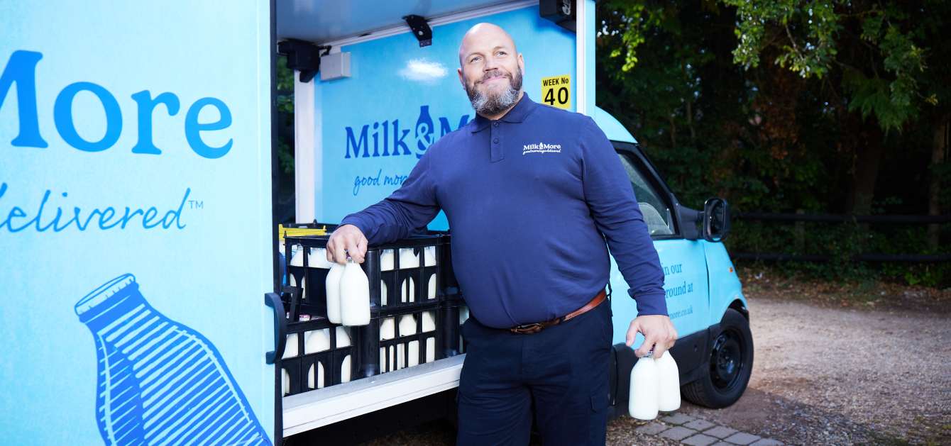 Milkman with glass milk bottles