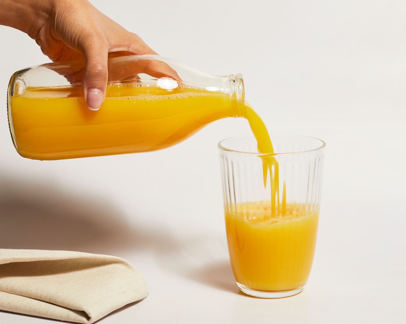 orange juice in glass bottle