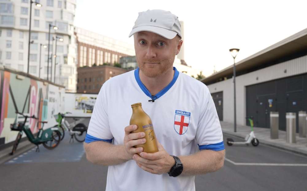 Theo Baker holding golden milk bottle