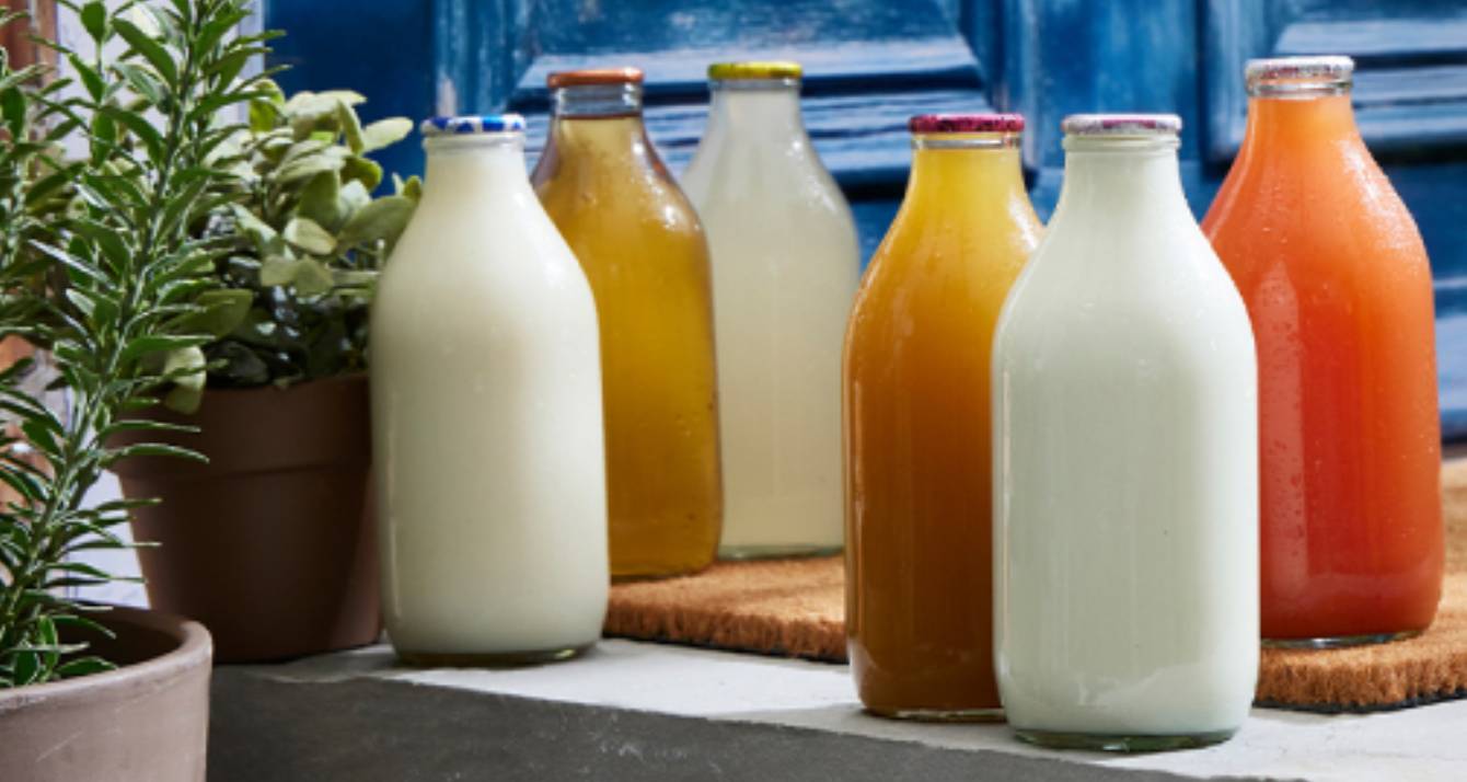 refillable glass milk and juice bottled on doorstep