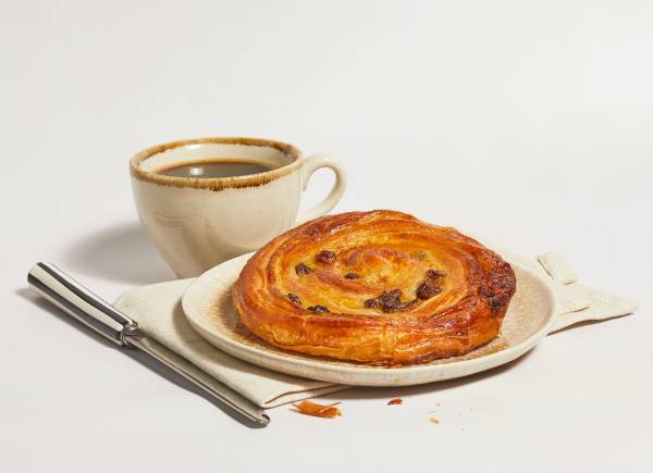pain aux raisins with cup of coffee